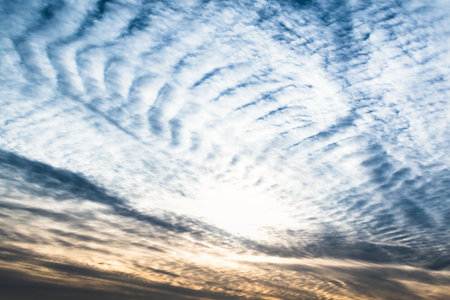 Beautiful striated cloud formation in sky looking like fluffy waves, weather forecastの写真素材