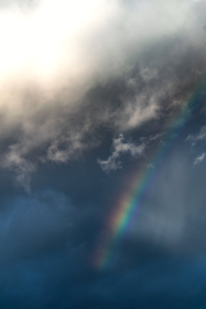 Rainbow on a spring day thanks to the rain and the sunの写真素材