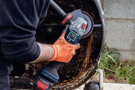Man using portable grinder with sparkles