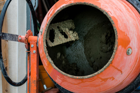 Concrete mixer mixing cement, sand and water to produce concreteの写真素材