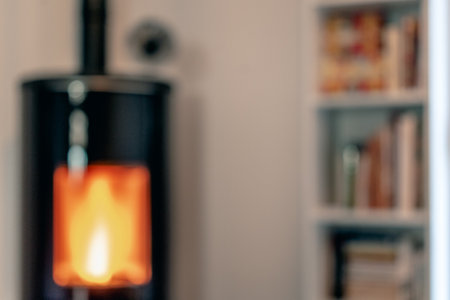 Blurred pellet stove in a living room with bookcase and heat diffuser for backgrounds use