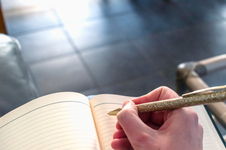 Woman writing in a notebookの写真素材