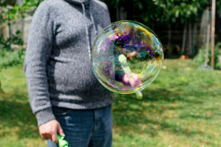 Soap bubble, outdoors activity and leisure for happy kid, real life photo