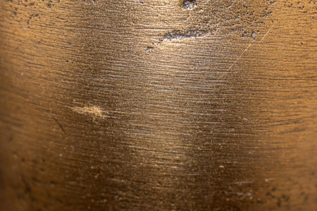 Golden background of an authentic image of an object, zoom on its texture for background and conceptの写真素材
