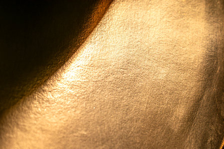 Golden background of an authentic image of an object, zoom on its texture for background and concept