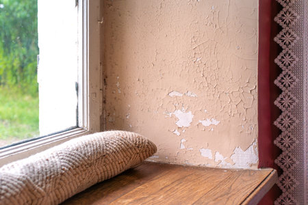 Old house with cracked wall and peeling paint