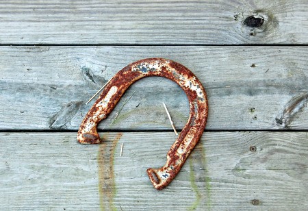 Horseshoe hangs on wooden boardsの写真素材