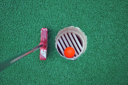 Miniature Golf Ball In The Holeの写真素材