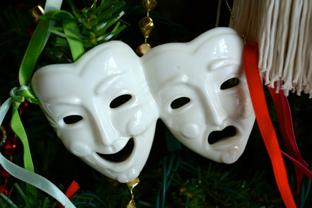 Theatre Mask Ornament hangs on a Christmas Treeの写真素材