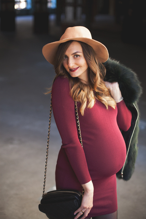 Beautiful pregnant woman in a hatの写真素材