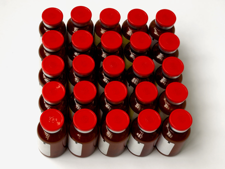 Vials with matter stand in rows on a white background