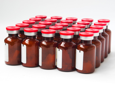 Vials with matter stand in rows on a white background