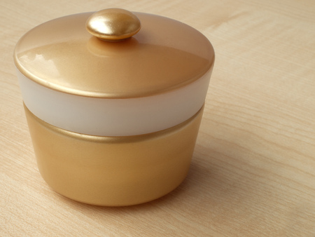 Jar with cream, isolated against a background of peach treeの写真素材