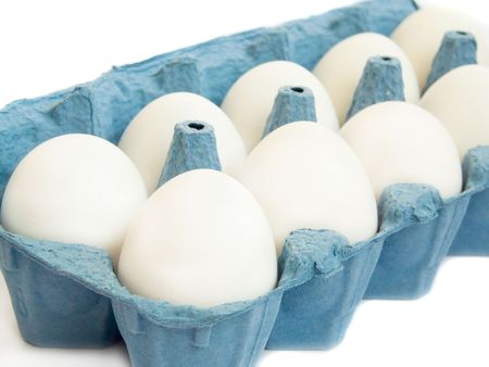 White eggs in blue cardboardの写真素材