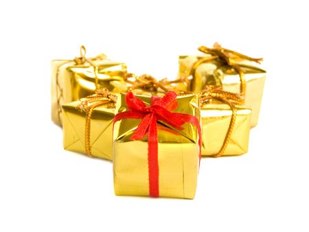 Small golden gifts, isolated over white Shallow DOF.の写真素材