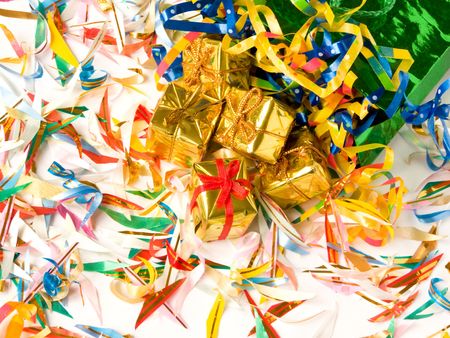 Small golden gifts around colored confetti. Shallow DOF.の写真素材