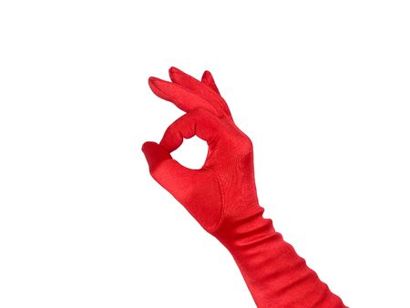 Female hand in red glove show a ok sign, isolated over white.の写真素材