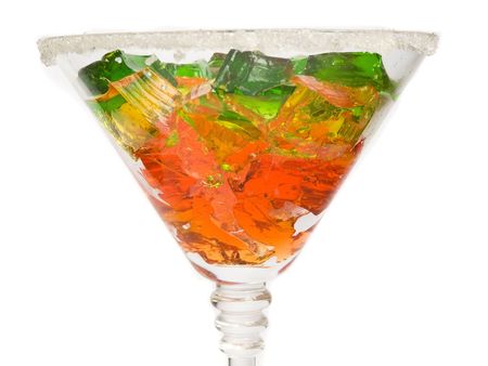 Glass with fruit jelly cubes, isolated over white. Shallow dof.の写真素材