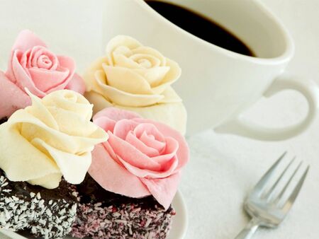 Small cream cakes and cup of coffee. Shallow dof.の写真素材