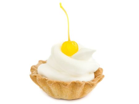 Tartlet with whipped cream and cherry, isolated over white.の写真素材