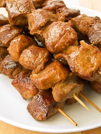 Plate with group of grilled pork kebabs. Shallow dof.の写真素材