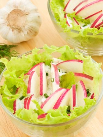 A glass bowls with radish salads. Shallow dof.の写真素材