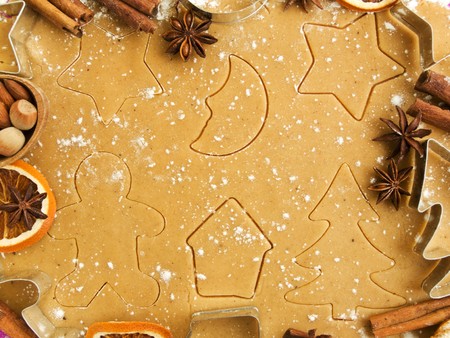 Christmas baking background: dough, cookie cutters, spices and nuts. Viewed from above.の写真素材