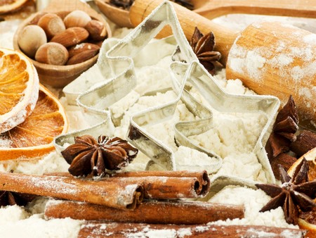 Christmas baking background: cookie cutters, flour, nuts and spices. Shallow dof.の写真素材