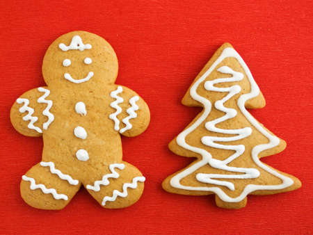 Homemade gingerbread tree and man cookies on the red background. Viewed from above.の写真素材