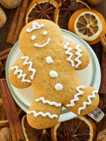 Milk and homemade gingerbread cookie for Santa. Viewed from above.