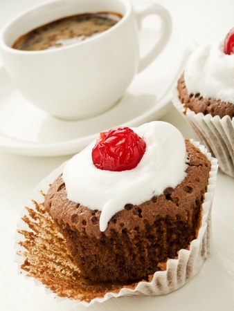 Chocolate cupcake with and coffee cup. Shallow dof.の写真素材