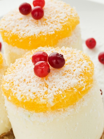 Sour cream cheesecakes with orange and candies. Shallow dof.の写真素材
