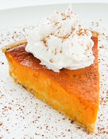 Homemade pumpkin pie with whipped cream. Shallow dof.の写真素材
