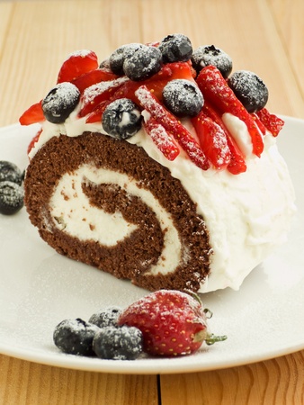 Strawberry-blueberry roulade with whipped sour cream. Shallow dof.の写真素材