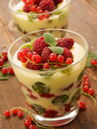 Glasses with lemon cream and fresh berries. Shallow dof.の写真素材