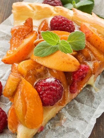 Slice of apricot-raspberry tart with lemon cream. Shallow dof.の写真素材