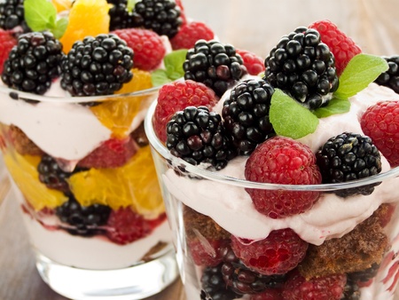 Glasses with raspberry-blackberry and orange parfait with whipped sour cream. Shallow dof.の写真素材