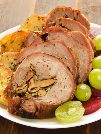 Roasted turkey roulade with potatoes, beet and grapes. Shallow dof.の写真素材