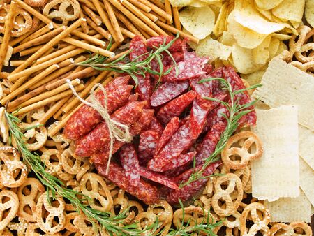 Wienerwurst, potato chips, pretzels and saltsticks background. Viewed from above.の写真素材