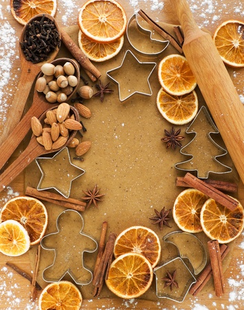 Christmas baking background dough, cookie cutters, spices and nuts. Viewed from above.の写真素材