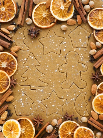Christmas baking background dough, cookie cutters, spices and nuts. Viewed from above.の写真素材