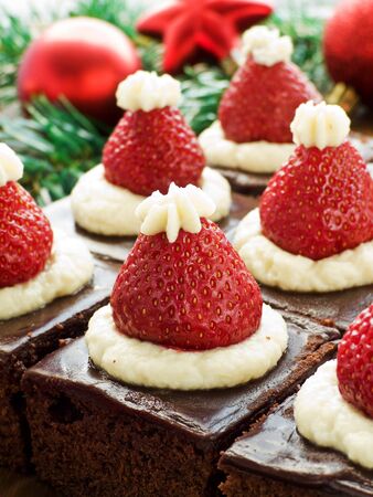 Santa hat brownie bites on the wooden background. Shallow dof.の写真素材