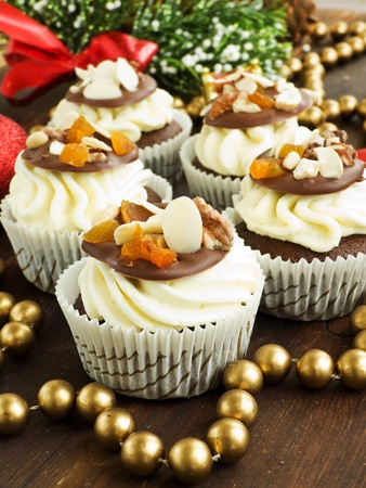 Christmas cupcakes with whipped cream and chocolate chip with nuts. Shallow dof.の写真素材