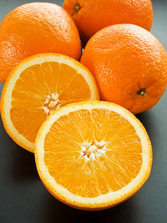 Group of fresh oranges on the black background. Shallow dof.