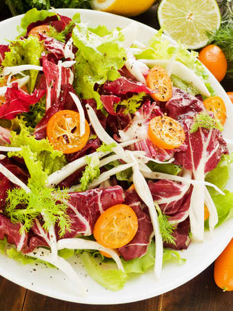 Salad with radicchio, fennel, lettuce and kumquat. Shallow dof.の写真素材