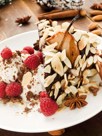 Christmas dessert pear cake with ice-cream and raspberries. Shallow dof.の写真素材
