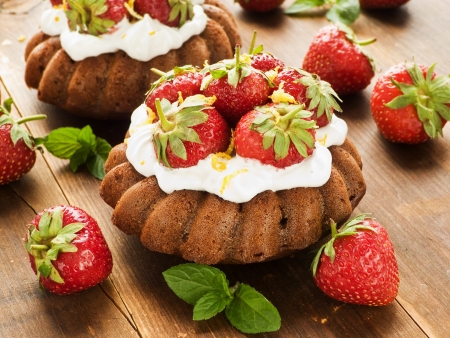 Coconut cakes with whipped cream and strawberry. Shallow dof.の写真素材