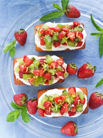 Coconut cakes with whipped cream, strawberry and kiwi. Shallow dof.の写真素材