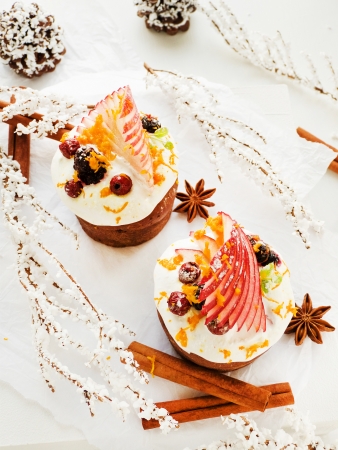 Chocolate cupcakes, with whipped cream, apple, mint and berries. Shallow dof. の写真素材