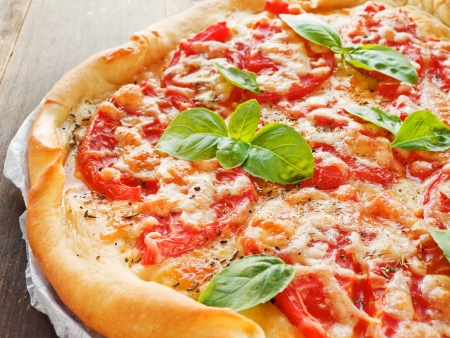 Pizza with tomatoes, cheese, herbs and baby basil  Shallow dof の写真素材